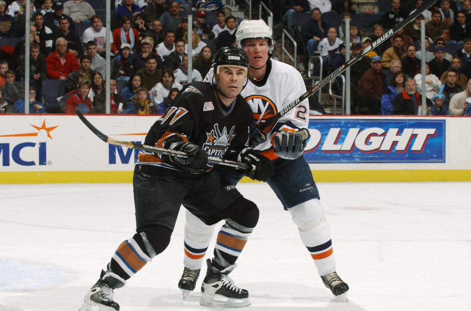 WASHINGTON - JANUARY 1: Adam Oates #17 of the Washington Capitals battles with defenseman Kenny Jonsson #29 of the New York Islanders during the game at the MCI Center in Washington D.C. on January 1, 2002. The Capitals defeated the Islanders 3-2. (Photo by Mitchell Layton/Getty Images/NHLI)