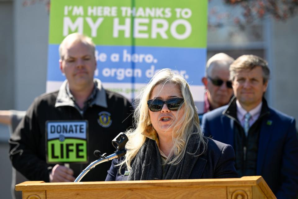 In April 2022 photo, Mass. Registrar of Motor Vehicles Colleen Ogilvie speaks during a press conference about organ donation. She says the rollout has been smooth for the law enacted six months ago that allows undocumented residents to seek driver's licenses.