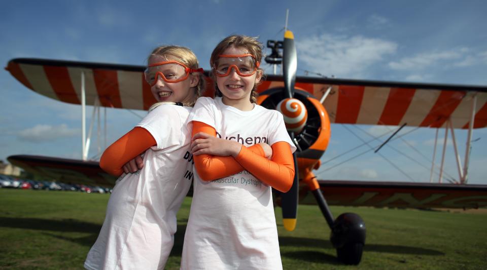 Nine-year-old cousins Rose Powell (left) and Flame Brewer prepare to go wing-walking over Rendcomb Airfield near Cirencester for the charity Duchenne Children's Trust.