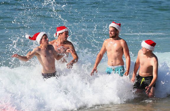 Tom Christian, Jordan Peters, Pete Addison and Tom Rigden from Kent, England, frolic in the water at Bondi Beach.