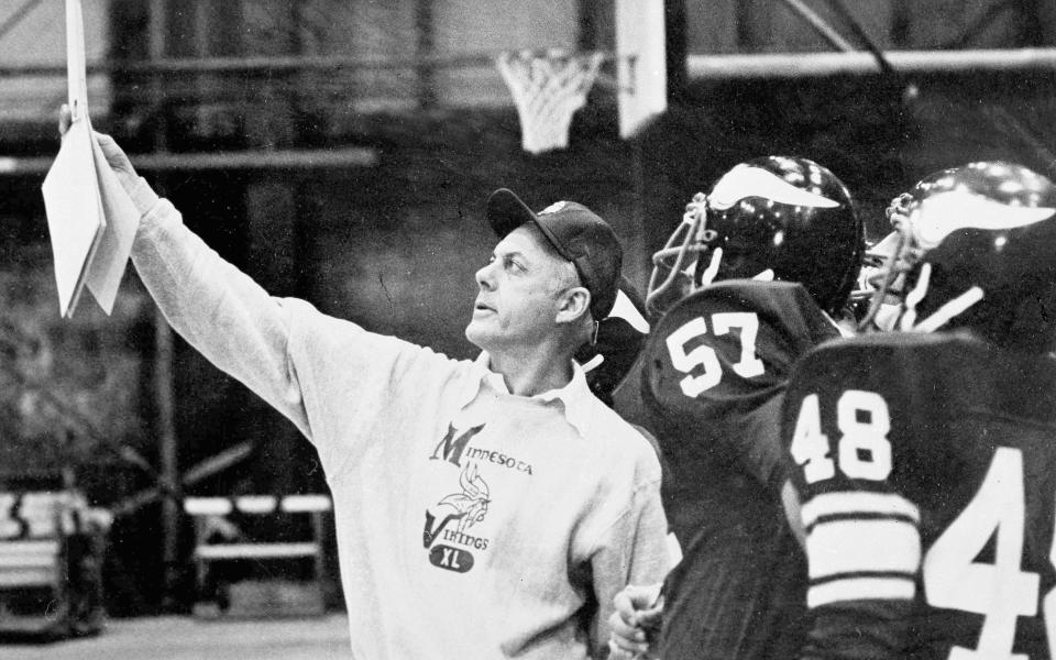 FILE - Minnesota Vikings coach bud Grant holds up chart containing Dallas Cowboys' offensive plays during NFL football practice in Minneapolis, Dec. 29, 1977. Grant, the stoic and demanding Hall of Fame coach who took the Minnesota Vikings and their mighty Purple People Eaters defense to four Super Bowls in eight years and lost all of them, has died. He was 95. (AP Photo/Larry Salzman, File)