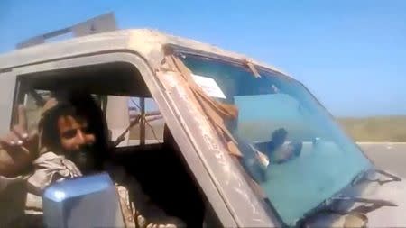 Members of UAE-backed fighters, Yemeni Resistance Giants' Brigade drive the truck near airport on the outskirts of Hodeidah, Yemen, June 19, 2018 in this still image taken from video. YEMENI RESISTANCE GIANTS' BRIGADE/REUTERS