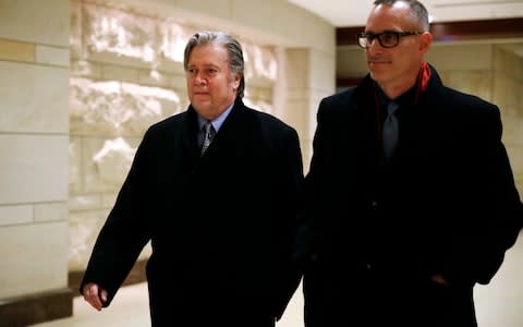 Former White House strategist Steve Bannon, left, leaves a House Intelligence Committee meeting - Credit: AP