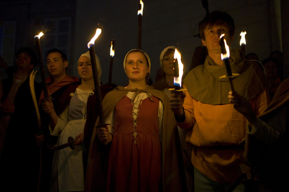 People dressed up like people from the Middle Age attend ceremonies marking the 600th anniversary of the birth of Joan of Arc, in Orleans, central France, Sunday April 29, 2012. The city of Orleans goes all out with celebrations marking the 600th birthday of Joan of Arc, a national icon and symbol of French resistance through the ages at a time when French identity and France's role in the world are a focus in the presidential campaign. (AP Photo/Thibault Camus)