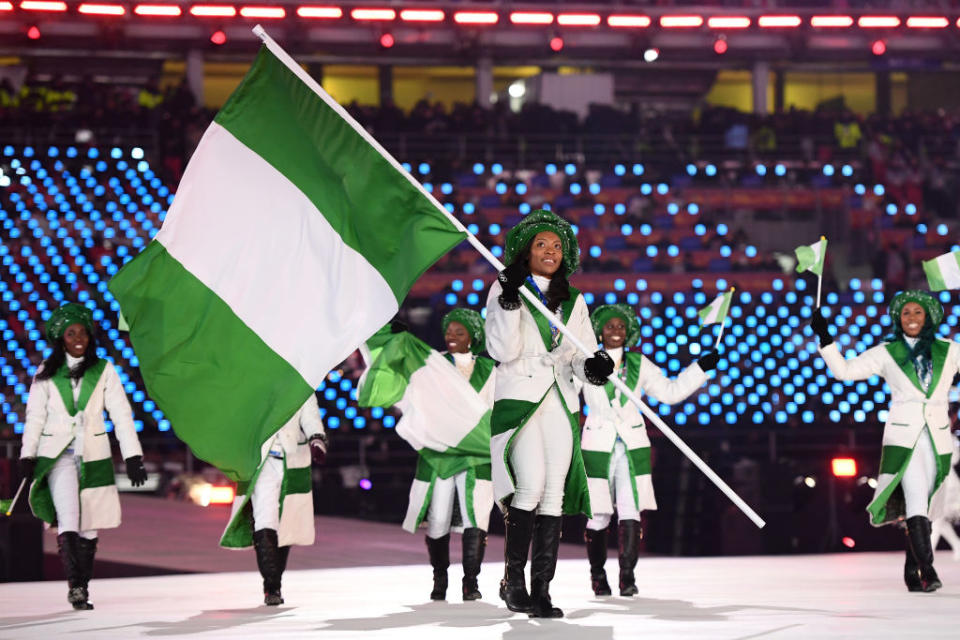 <p>Flag bearer Ngozi Onwumere of Nigeria leads the team wearing chic white coats with green lapels during the opening ceremony of the 2018 PyeongChang Games. (Photo: Quinn Rooney/Getty Images) </p>