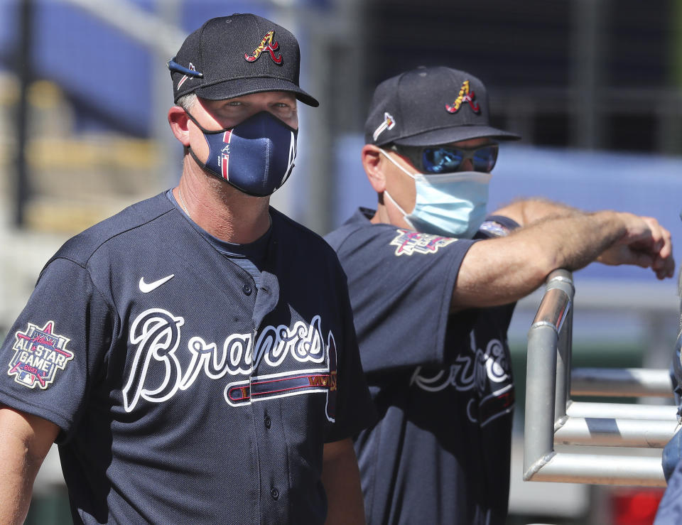 Atlanta Braves Hall of Fame third baseman Chipper Jones and manager Brian Snitker watch batting practice during spring baseball training Tuesday, Feb. 23, 2021, in North Port, Fla. (Curtis Compton/Atlanta Journal-Constitution via AP)