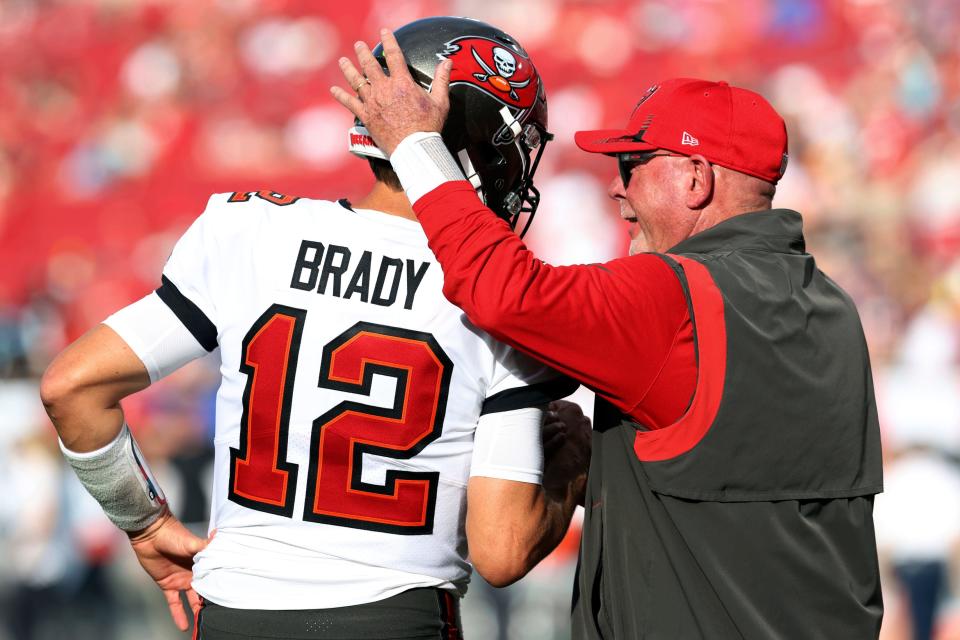 FILE - Tampa Bay Buccaneers head coach Bruce Arians talks to quarterback Tom Brady (12) before an NFL football game against the Carolina Panthers, Sunday, Jan. 9, 2022, in Tampa, Fla. Tom Brady has retired after winning seven Super Bowls and setting numerous passing records in an unprecedented 22-year-career. He made the announcement, Tuesday, Feb. 1, 2022, in a long post on Instagram.  (AP Photo/Mark LoMoglio, File)