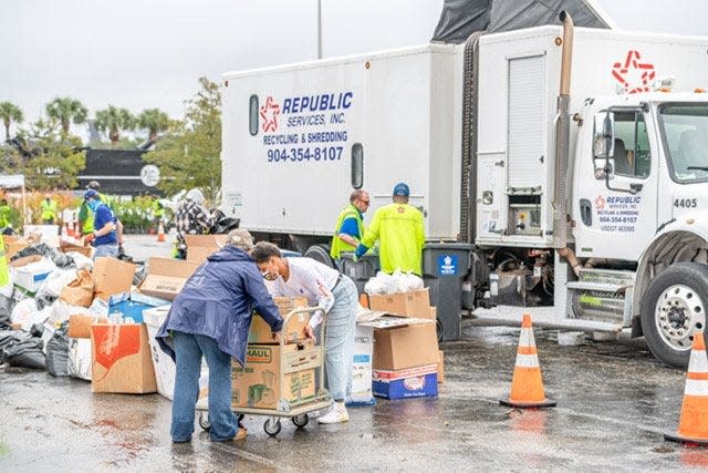 Volunteers load and unload boxes and bags of documents and paperwork dropped off by residents for Jacksonville's 2020 America Recycling Day event. This year's free service will be this Saturday in TIAA Bank Field's parking lot.