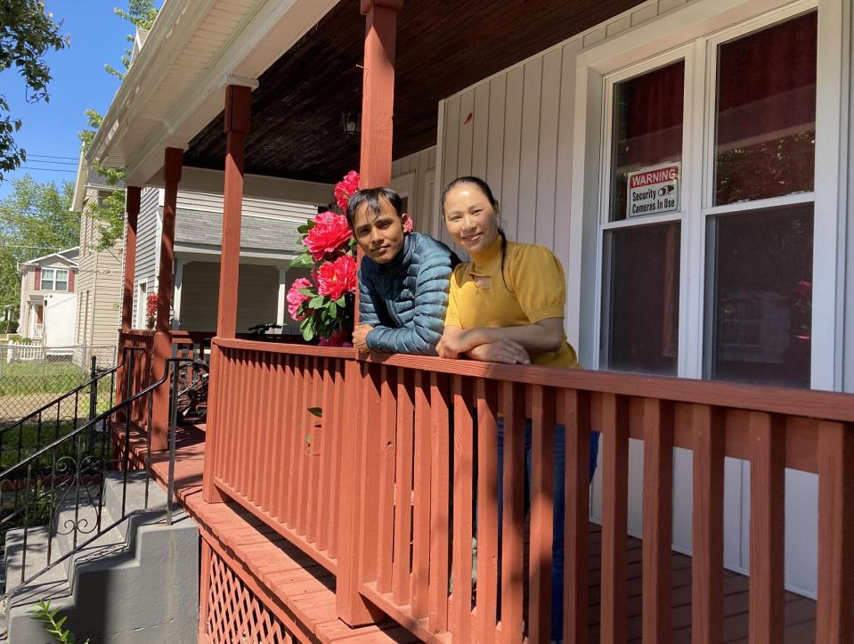 Anil and Dirpa Pradhan stand on the porch of their home at 352 W. 17th St. The Bhutanese couple lived for 26 years at refugee camps in Nepal before moving to Erie. They bought the home in 2020, thanks to the Genesis Home Buying Program.