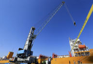 CORRECTS DAY TO TUESDAY -- A cable hangs from a crane at the site of a toxic gas explosion in Jordan's Red Sea port of Aqaba, Tuesday, June 28, 2022. A crane loading chlorine tanks onto a ship on Monday dropped one of them, causing an explosion of toxic yellow smoke that killed over a dozen people and sickened some 250, authorities said. (AP Photo/Raad Adayleh)