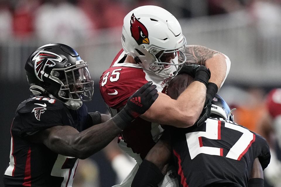 Arizona Cardinals tight end Trey McBride (85) is hit by Atlanta Falcons safety Richie Grant (27) during the first half of an NFL football game, Sunday, Jan. 1, 2023, in Atlanta. (AP Photo/Brynn Anderson)
