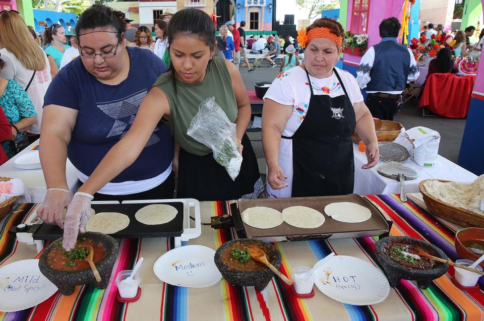 Lucy, (from left) Gabby and Ana Cardenas prepare fresh tortillas and salsa in the Cultural Pavilion during Mexican Fiesta in 2015.