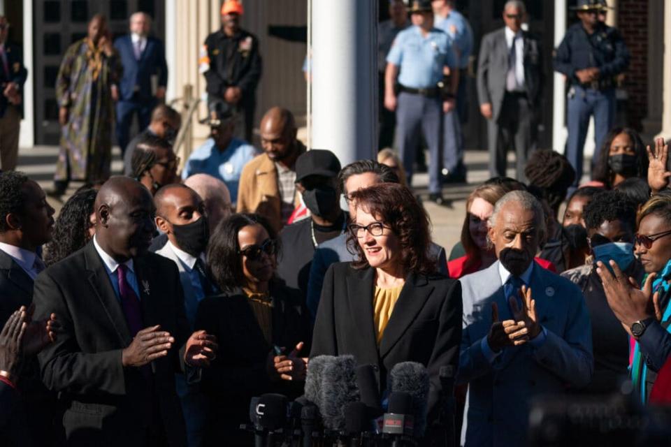 Lead prosecutor Linda Dunikoski is applauded while addressing members of the media outside the Glynn County Courthouse after guilty verdicts were announced for the defendants in the trial of the killers of Ahmaud Arbery on November 24, 2021 in Brunswick, Georgia. (Photo by Sean Rayford/Getty Images)