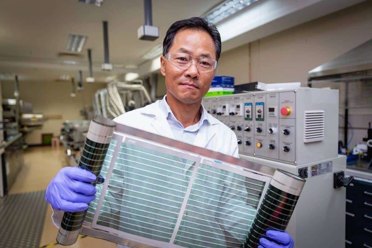 Dr Doojin Vak holds up a roll of flexible printed solar cells that use the ‘miracle material’ perovskite (CSIRO)