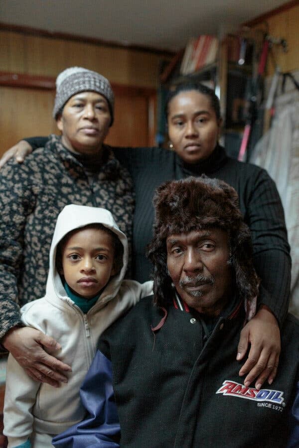 Family members Curen Sutherland-Goddard, far left, Amanda Sutherland and Bella Clarke visited Mr. Roberts last week. The apartment has not had heat since the property changed in hands in April, Mr. Roberts said.