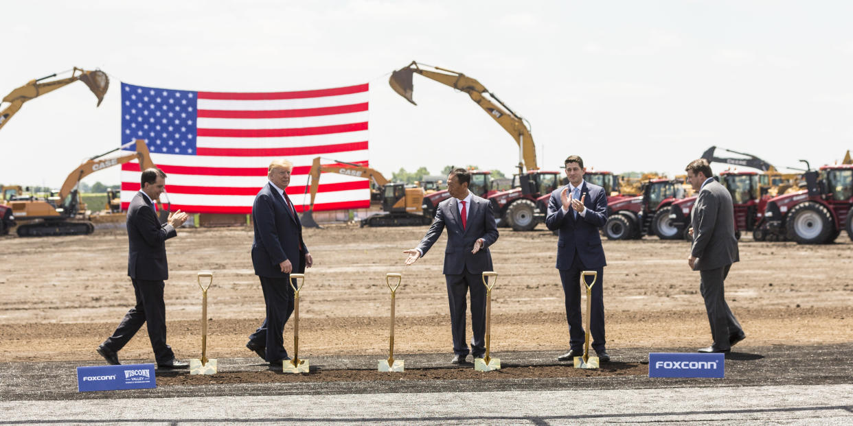 MT PLEASANT, WI - JUNE 28: Foxconn CEO Terry Gou (3rd R) gestures to U.S. President Donald Trump (2nd L) at the groundbreaking of the Foxconn Technology Group computer screen plant on June 28, 2018 in Mt Pleasant, Wisconsin. The president was joined by Wisconsin Gov. Scott Walker (L), U.S. House Speaker Paul Ryan (R-WI) (2nd R) and Christopher “Tank” Murdock (R), the first Wisconsin Foxconn employee. Foxconn has committed to build a $10 billion plant in what it has named the Wisconn Valley Science and Technology Park, and to creating 13,000 Wisconsin jobs. (Photo by Andy Manis/Getty Images)