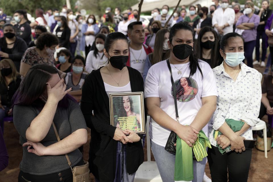 Friends and relatives of Leidy Vanessa Luna Villalba gather outside her home as the coffin that contain her remains arrives in Eugenio Garay, Paraguay, Tuesday, July 13, 2021. Luna Villalba, a nanny employed by the sister of Paraguay's first lady Silvana Lopez Moreira, was among those who died in the Champlain Towers South condominium collapse in Surfside, Florida on June 24. (AP Photo/Jorge Saenz)