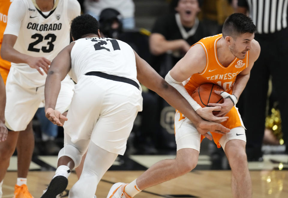 Tennessee forward John Fulkerson, right, recovers a loose ball as Colorado forward Evan Battey defends in the first half of an NCAA college basketball game Saturday, Dec. 4, 2021, in Boulder, Colo. (AP Photo/David Zalubowski)