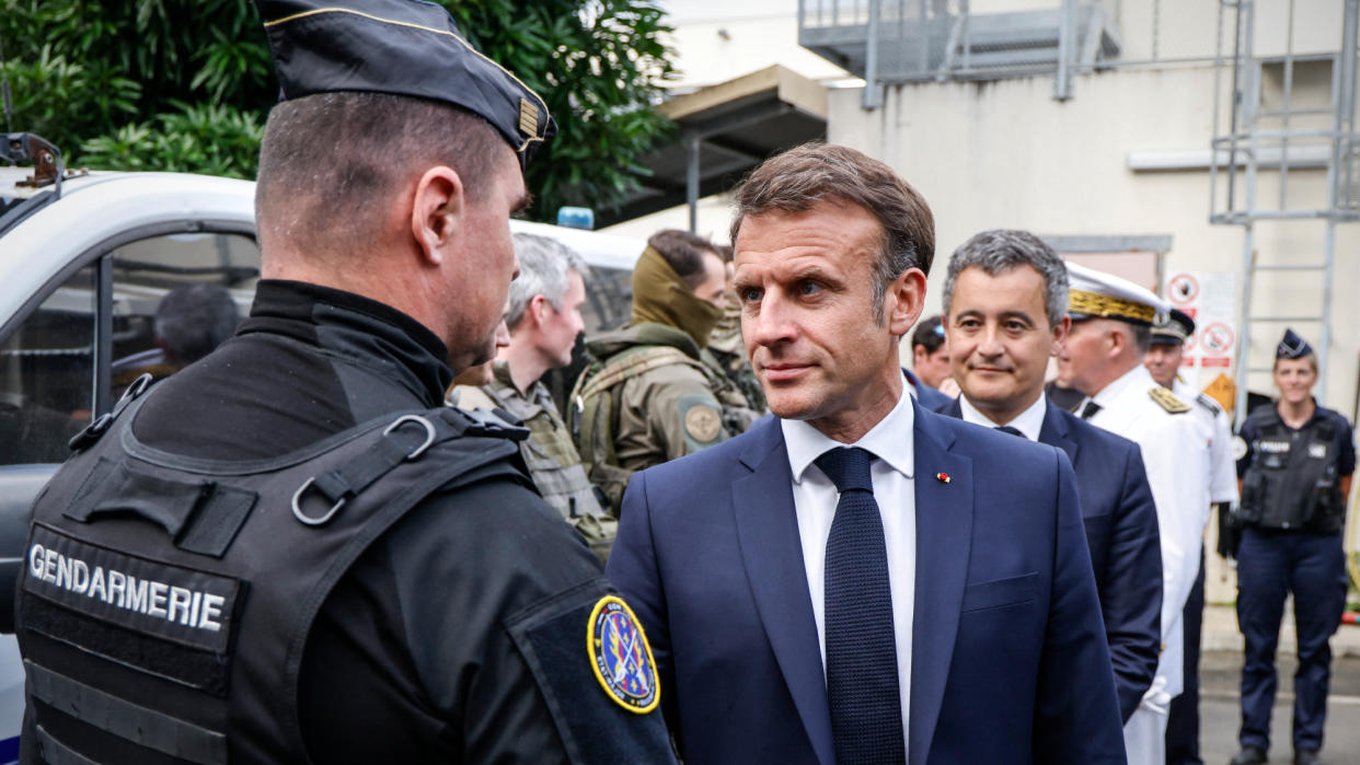  French President Emmanuel Macron greets police in New Caledonia. 