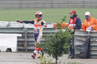 Actual World Champion MotoGP Honda rider Marc Marquez of Spain stretches his arms after falling from his bike during the Motorcycle Grand Prix at the Ricardo Tormo circuit in Cheste near Valencia, Spain, Sunday, Nov. 18, 2018. (AP Photo/Alberto Saiz)