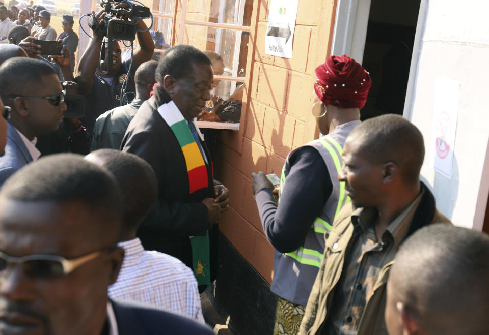 Zimbabwean President Emmerson Mnangagwa arrives at a polling station to cast his vote, in Kwekwe, Zimbabwe, Wednesday, Aug. 23, 2023. Polls have opened in Zimbabwe as President Emmerson Mnangagwa seeks a second and final term in a country with a history of violent and disputed votes. (AP Photo)