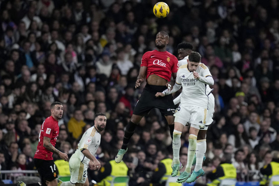 Mallorca's Jose Manuel Copete jumps for the ball with Real Madrid's Federico Valverde during the Spanish La Liga soccer match between Real Madrid and Mallorca at the Santiago Bernabeu stadium in Madrid, Spain, on Wednesday, January 3, 2024. (AP Photo/Bernat Armangue)