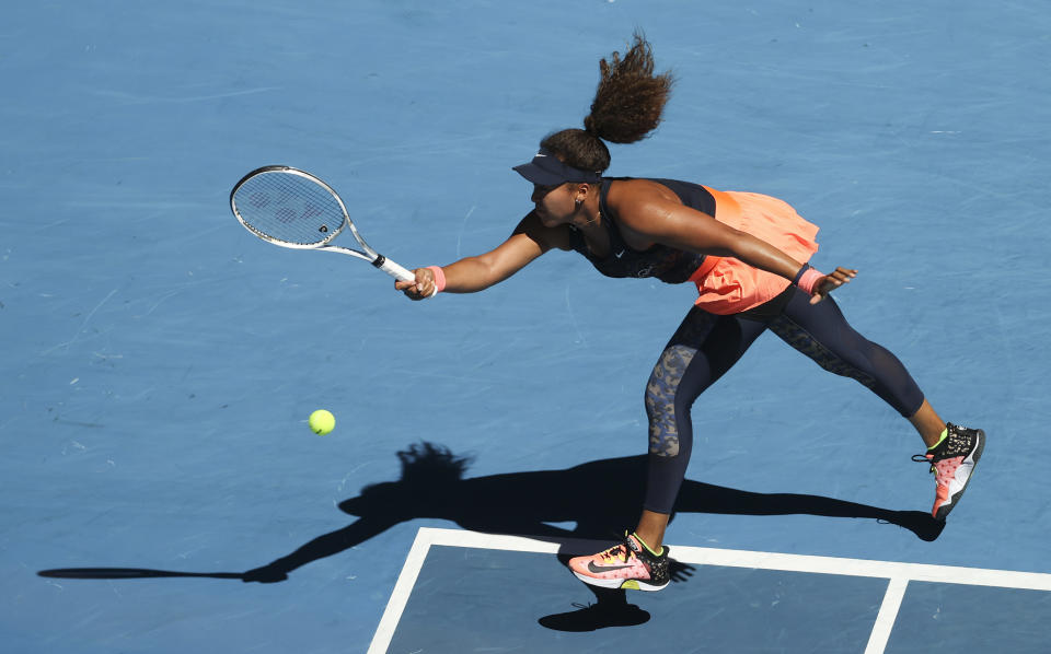 Japan's Naomi Osaka hits a forehand return to United States' Serena Williams during their semifinal match at the Australian Open tennis championship in Melbourne, Australia, Thursday, Feb. 18, 2021.(AP Photo/Hamish Blair)