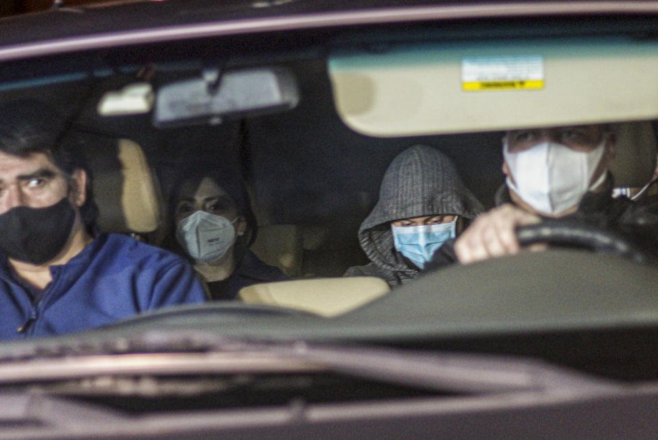 Nicolas Zepeda, center right, is driven in a car by police investigators from his home, where he was under house arrest, one day prior his extradition to France, in Viña del Mar, Chile, Wednesday, July 22, 2020. Zepeda faces charges related to the 2016 murder of his former Japanese girlfriend Narumi Kurosaki. (AP Photo/Lucas Aguayo)