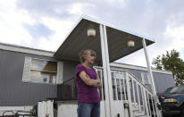 ADVANCE ON THURSDAY, SEPT. 12 FOR USE ANY TIME AFTER 3:01 A.M. SUNDAY SEPT 15 - In this Aug. 30th 2019 photo shows Karla Lyons, outside her mobile home at the Lamplighter Village in Federal Heights, Colo. Lyons' waitressing wages are eaten up by a constant stream of home and yard repairs ordered by her park manager, including removal of a giant maple tree that fell on her patio roof and crushed it. She would move if she could afford it. (Kathryn Scott/The Colorado Sun)