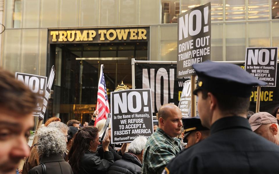 Protesters gather outside of Trump Tower a day after FBI Director James Comey was fired - Credit: Getty