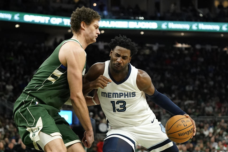 Memphis Grizzlies' Jaren Jackson Jr. (13) drives to the basket against Milwaukee Bucks' Brook Lopez during the second half of an NBA basketball game Wednesday, April 3, 2024, in Milwaukee. (AP Photo/Aaron Gash)