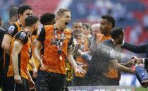 Britain Soccer Football - Hull City v Sheffield Wednesday - Sky Bet Football League Championship Play-Off Final - Wembley Stadium - 28/5/16 Hull City's Michael Dawson is sprayed with champagne as they celebrate winning promotion back to the Premier League Action Images via Reuters / Andrew Couldridge Livepic EDITORIAL USE ONLY. No use with unauthorized audio, video, data, fixture lists, club/league logos or "live" services. Online in-match use limited to 45 images, no video emulation. No use in betting, games or single club/league/player publications. Please contact your account representative for further details.