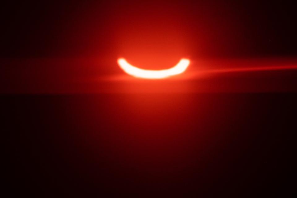 The eclipsed sun rises over Tobermory in Ontario, Canada (AFP via Getty Images)