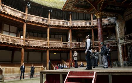 U.S. President Barack Obama watches a selection of songs and excerpts from Hamlet as he tours the Globe Theatre in London to mark the 400th anniversary of William Shakespeare's death April 23, 2016. REUTERS/Kevin Lamarque