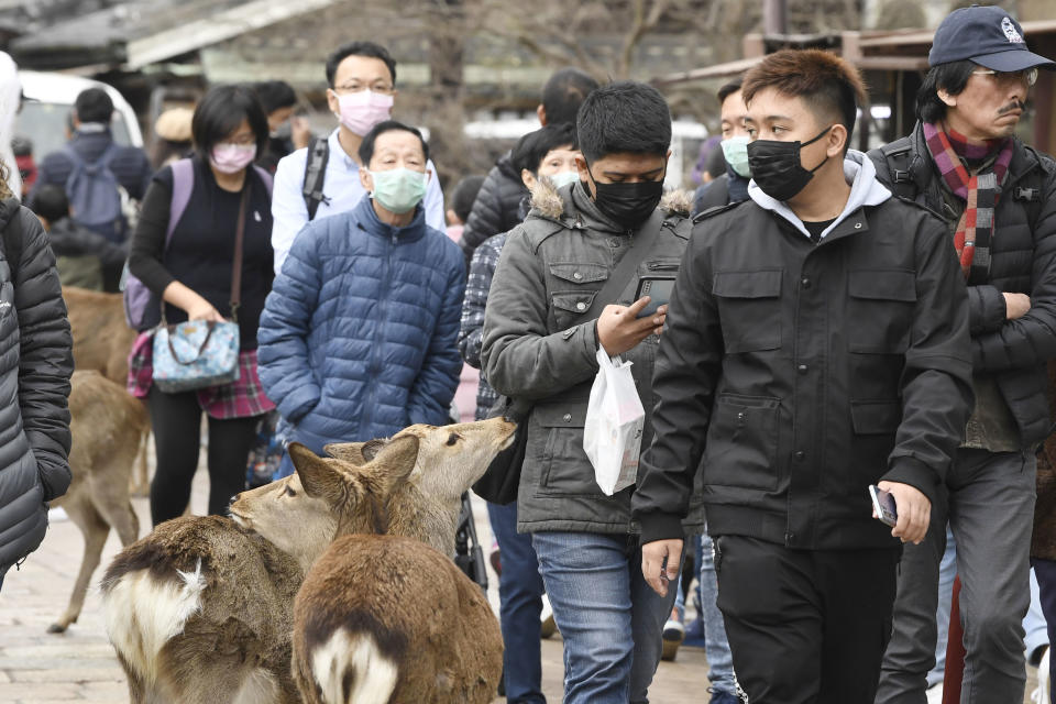 People wearing face masks in Western Japan as deadly coronavirus spreads across the world. Source: AP