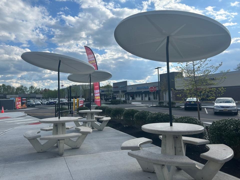 outdoor tables with umbrellas on the patio at checkers