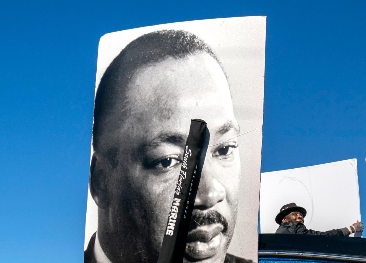 The Lindsey Davis senior program is respresented with large photos during the Martin Luther King Jr. Day Parade along Blue Heron Blvd., in Riviera Beach, Florida on January 14, 2023. 