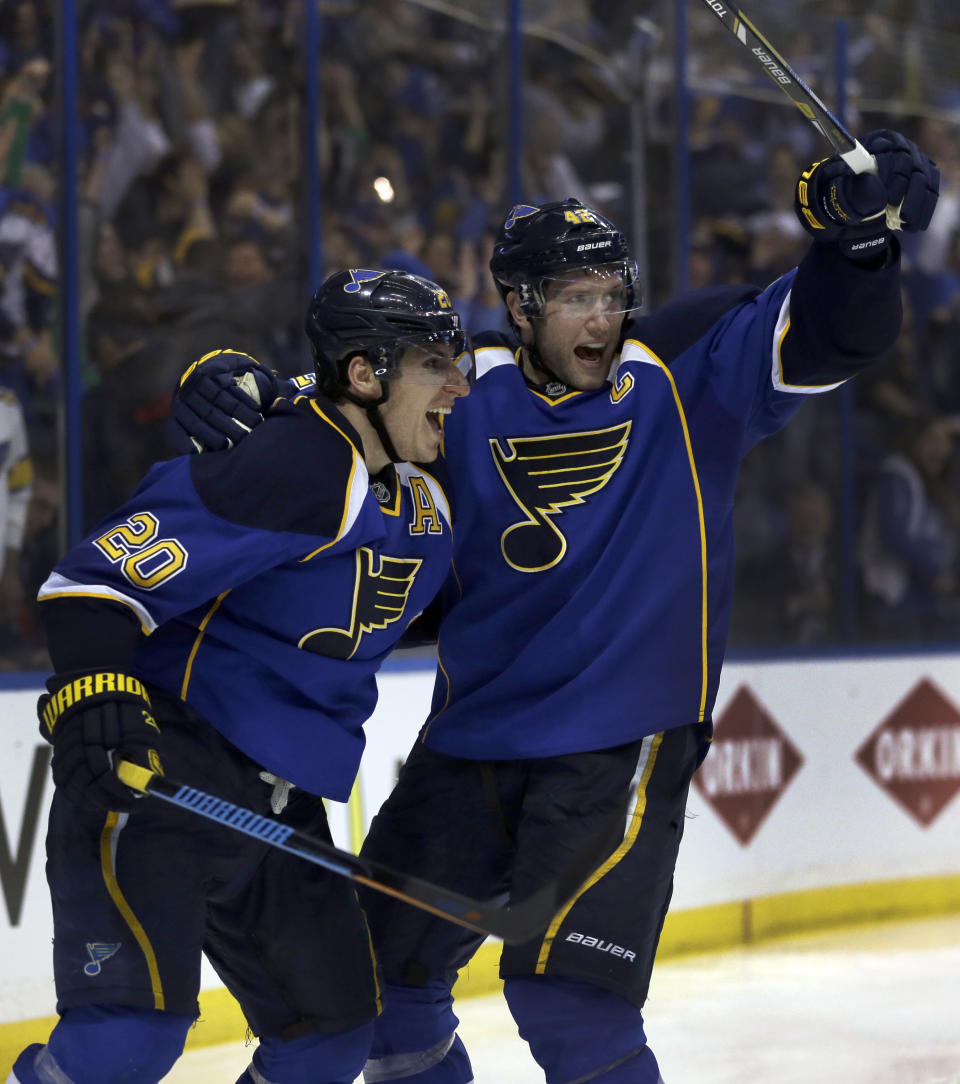 St. Louis Blues' Alexander Steen, left, is congratulated by teammate David Backes after scoring the game-winning goal during the third overtime in Game 1 of a first-round NHL hockey Stanley Cup playoff series against the Chicago Blackhawks Thursday, April 17, 2014, in St. Louis. The Blues won 4-3 in triple overtime. (AP Photo/Jeff Roberson)