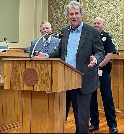 Sen. Sherrod Brown speaking recently in Zanesville with Mayor Don Mason and Chief Scott Comstock.