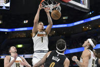 Denver Nuggets forward Michael Porter Jr. (1) dunks in the second half of an NBA basketball game against the Memphis Grizzlies, Sunday, April 14, 2024, in Memphis, Tenn. (AP Photo/Brandon Dill)