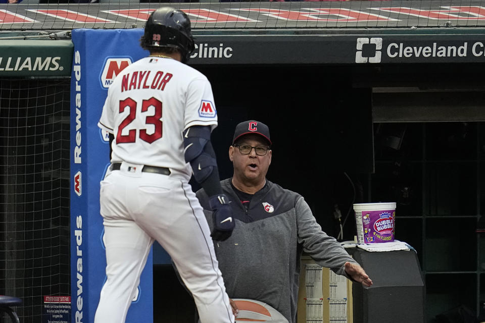 Cleveland Guardians manager Terry Francona, right, greets Bo Naylor (23), who returns to the dugout after hitting a home run against the Cincinnati Reds during the second inning of a baseball game Tuesday, Sept. 26, 2023, in Cleveland. (AP Photo/Sue Ogrocki)