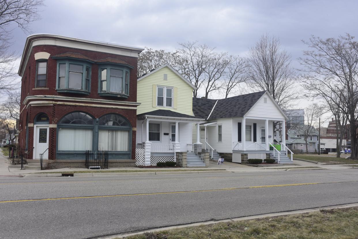 The city of Port Huron is buying the house at 1003 Erie St., center, on a block between Rawlins and Lincoln streets, as shown on March 30, 2022. To the north is land owned by a property management group associated with McLaren Port Huron. City officials are using federal COVID stimulus funds to buy property as part of a multi-year push to address a housing shortage in the region.