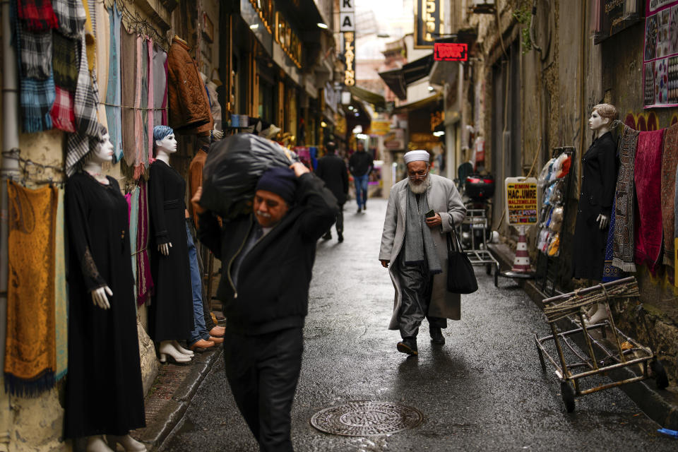 People walk along a street at Eminonu commercial area in Istanbul, Turkey, Wednesday, March 20, 2024. On Sunday, millions of voters in Turkey head to the polls to elect mayors and administrators in local elections which will gauge President Recep Tayyip Erdogan’s popularity as his ruling party tries to win back key cities it lost five years ago. (AP Photo/Emrah Gurel)