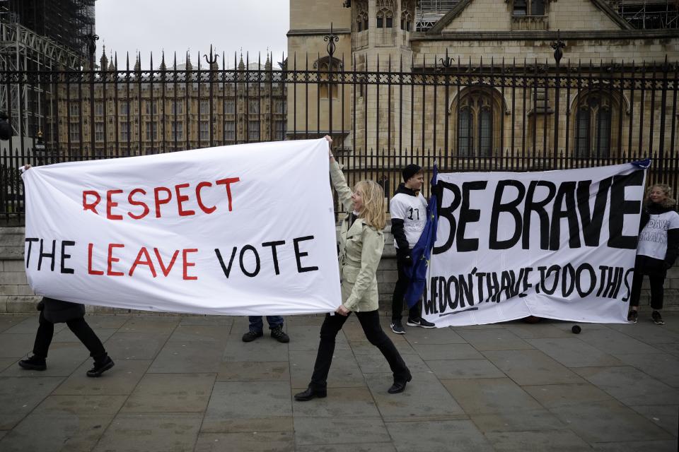 Pro-Brexit leave the European Union supporters, left, and anti-Brexit remain in the European Union supporters take part in a protest outside the Houses of Parliament in London, Tuesday, March 12, 2019. British Prime Minister Theresa May faced continued opposition to her European Union divorce deal Tuesday despite announcing what she described as "legally binding" changes in hopes of winning parliamentary support for the agreement. (AP Photo/Matt Dunham)