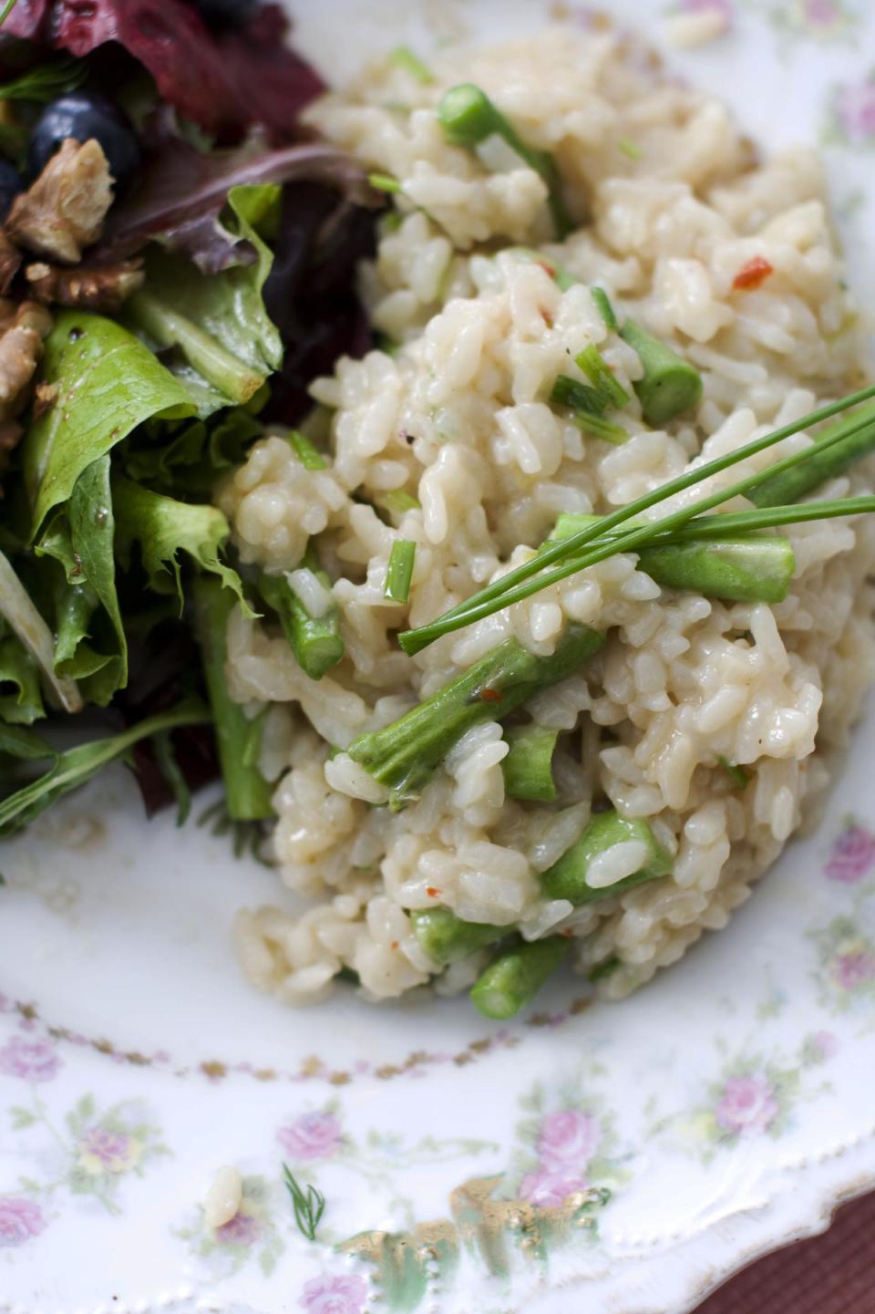 In this image taken on March 11, 2013, pressure cooker risotto with asparagus is shown served on a plate in Concord, N.H. (AP Photo/Matthew Mead)