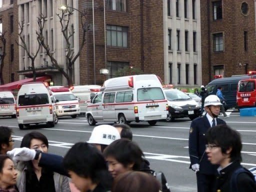Ambulances gather outside Kudan Kaikan hall where the ceiling of a school collapsed amid the massive 8.9-magnitude earthquake which rocked Tokyo. The strongest earthquake ever to hit Japan has unleashed a terrifying 10-metre tsunami that washed away homes and tossed ships inland, with a nuclear plant among multiple sites set ablaze