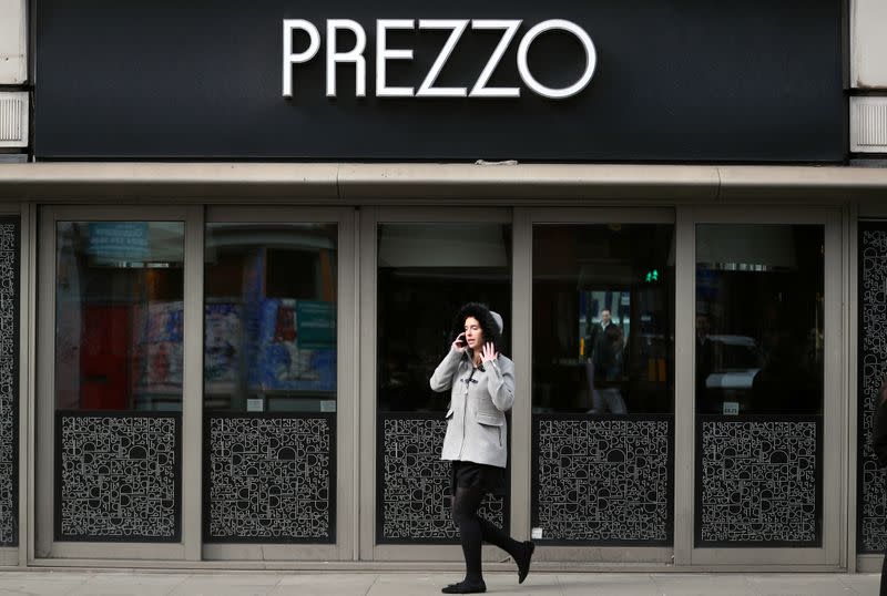 A woman walks past a Prezzo restaurant in London