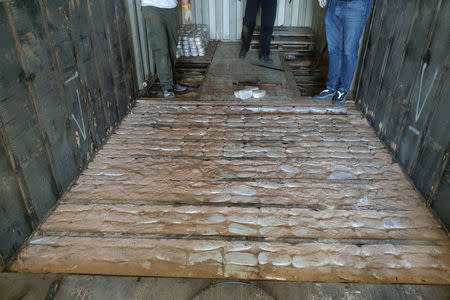 Packages of drugs are seen under the bottom of a container of the cargo ship "Noka" following an operation of the Hellenic Coast Guard, in which cannabis and super-strength amphetamine pills worth more than 100 million euros were confiscated, at the port of Heraklion on the island of Crete, Greece, December 13, 2018. Hellenic Coast Guard/Handout via REUTERS