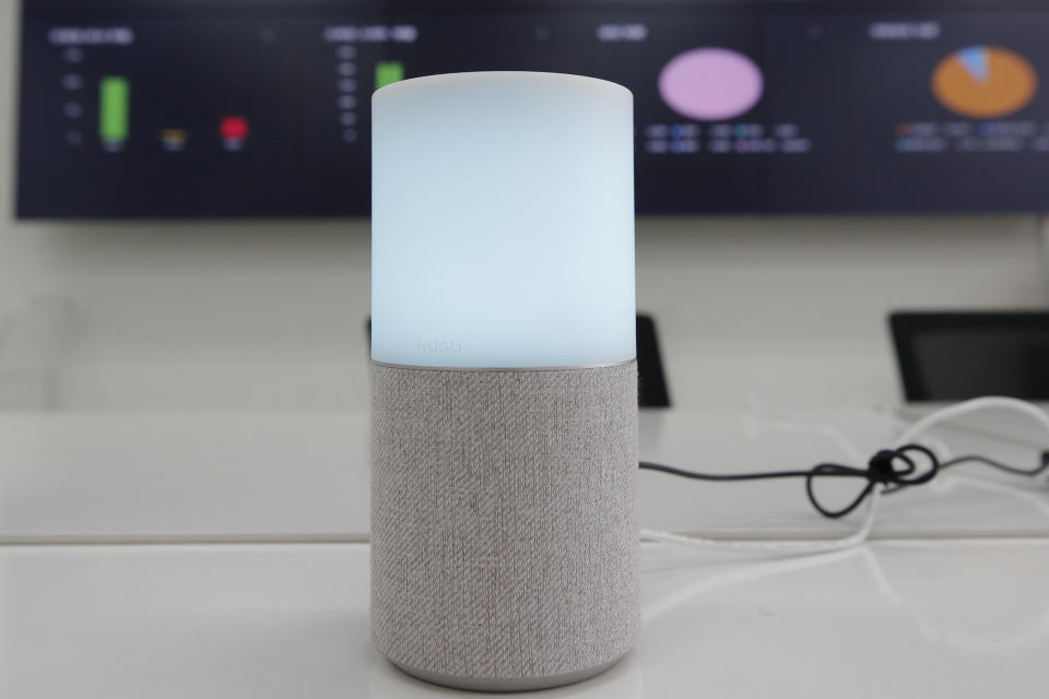 SK Telecom's AI speaker Nugu built with an artificial intelligence called "Aria" and a lamp that turns blue when processing voice commands for news, music and internet searches, is seen in Seoul, South Korea, on May 13, 2020. The devices can also use quizzes to monitor the memory and cognitive functions of their elderly users, which would be potentially useful for advising treatments. (AP Photo/Lee Jin-man)