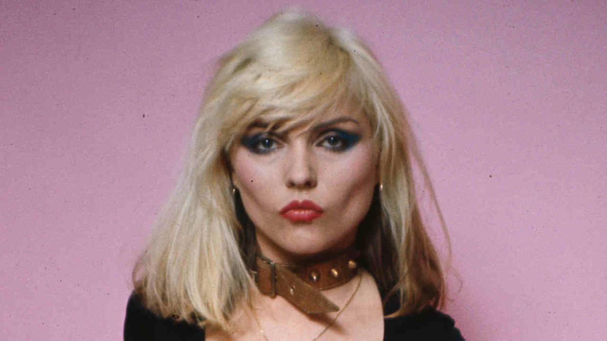  Blondie’s Debbie Harry in front of a pink backdrop. 